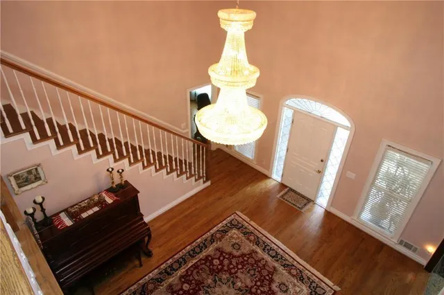 a view of entryway and hall with wooden floor