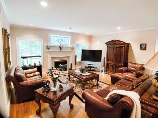 a living room with furniture a fireplace and a flat screen tv