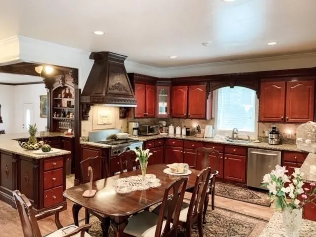a kitchen with granite countertop a sink and wooden cabinets