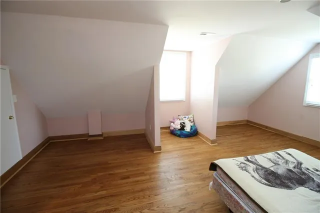 a view of an empty room and wooden floor