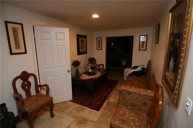 a living room with furniture and a mirror