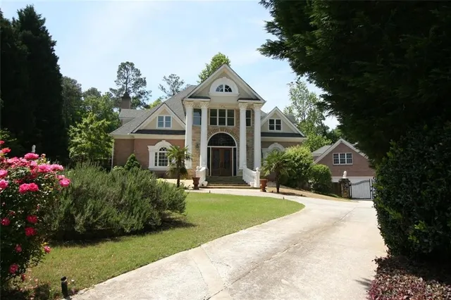 a front view of a house with a garden