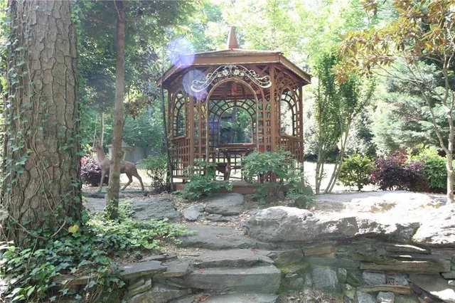 a front view of a house with yard and trees