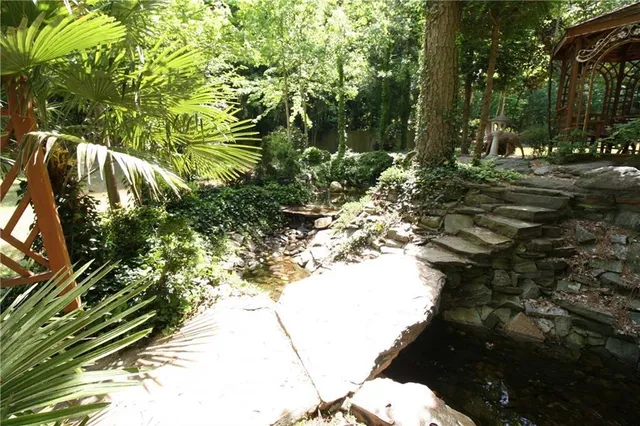 a backyard of a house with a garden and outdoor seating