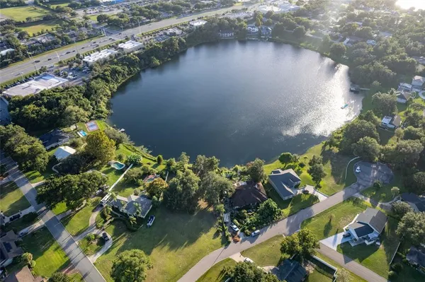 an aerial view of a houses with a lake view