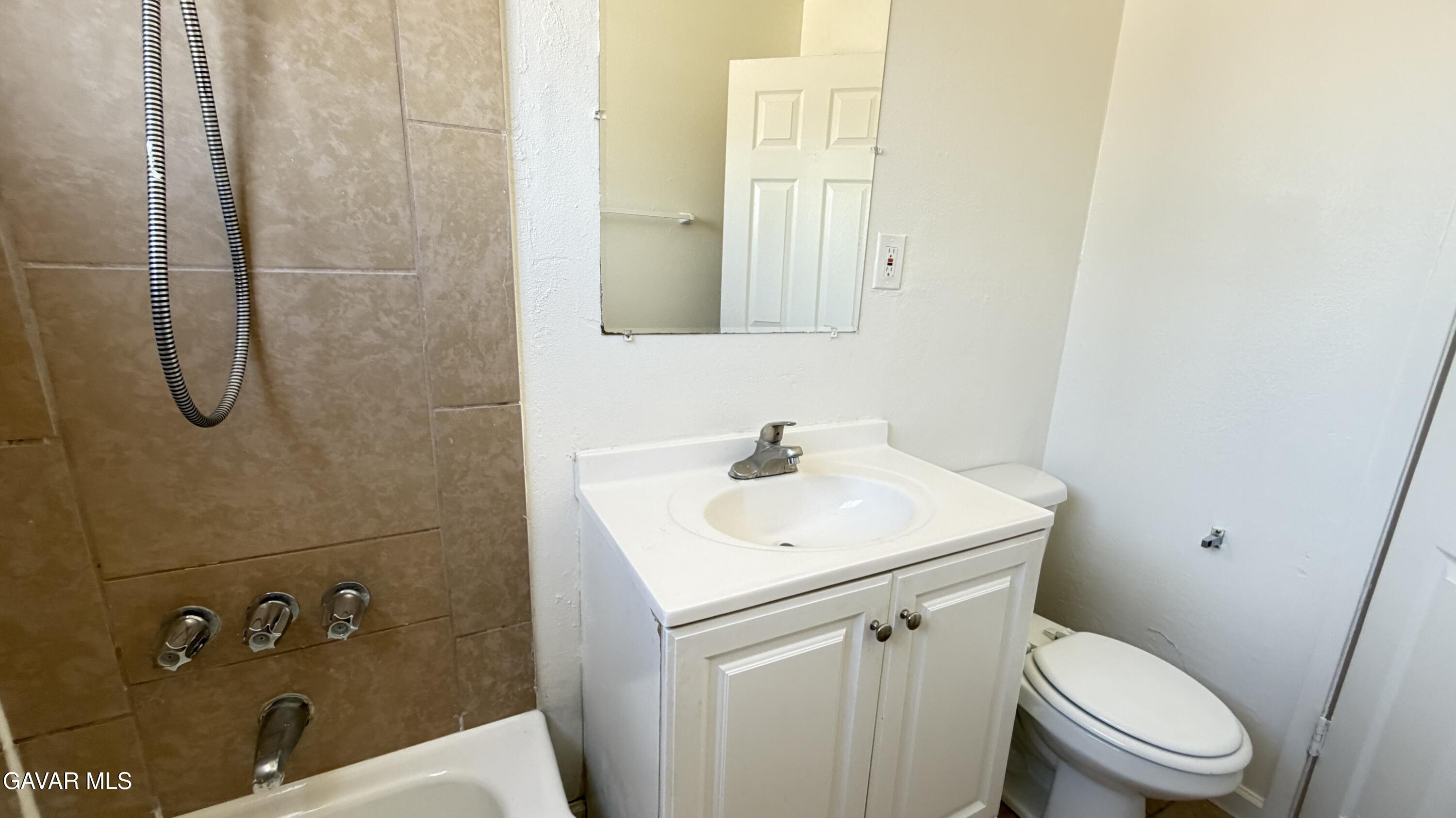 44226 2nd Street East Lancaster, CA 93535 - Photo 19 of 24 a bathroom with a sink a toilet and shower