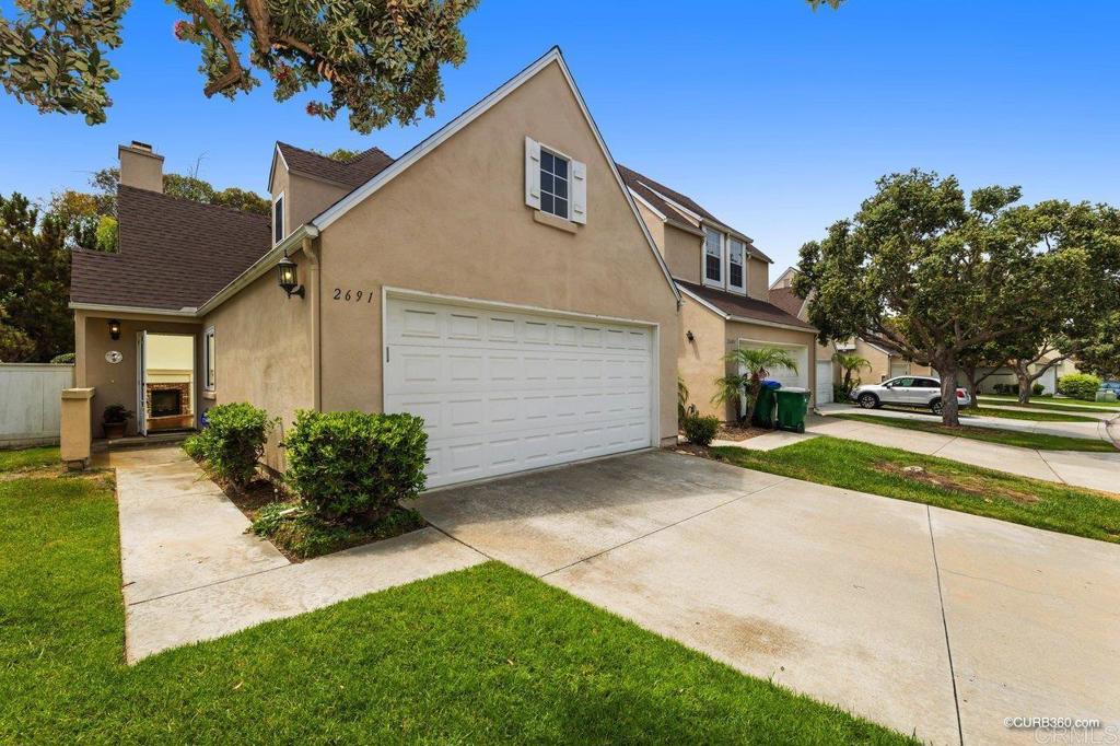 2691 Regent Road Carlsbad, CA 92010 - Photo 1 of 1 a front view of a house with garden