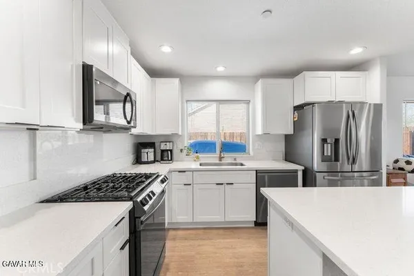 a kitchen with a sink a stove and refrigerator