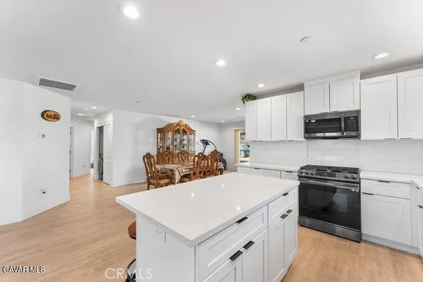 a kitchen with a sink a stove and cabinets