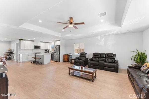 a living room with furniture and kitchen view