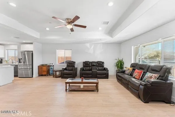 a living room with furniture and kitchen view