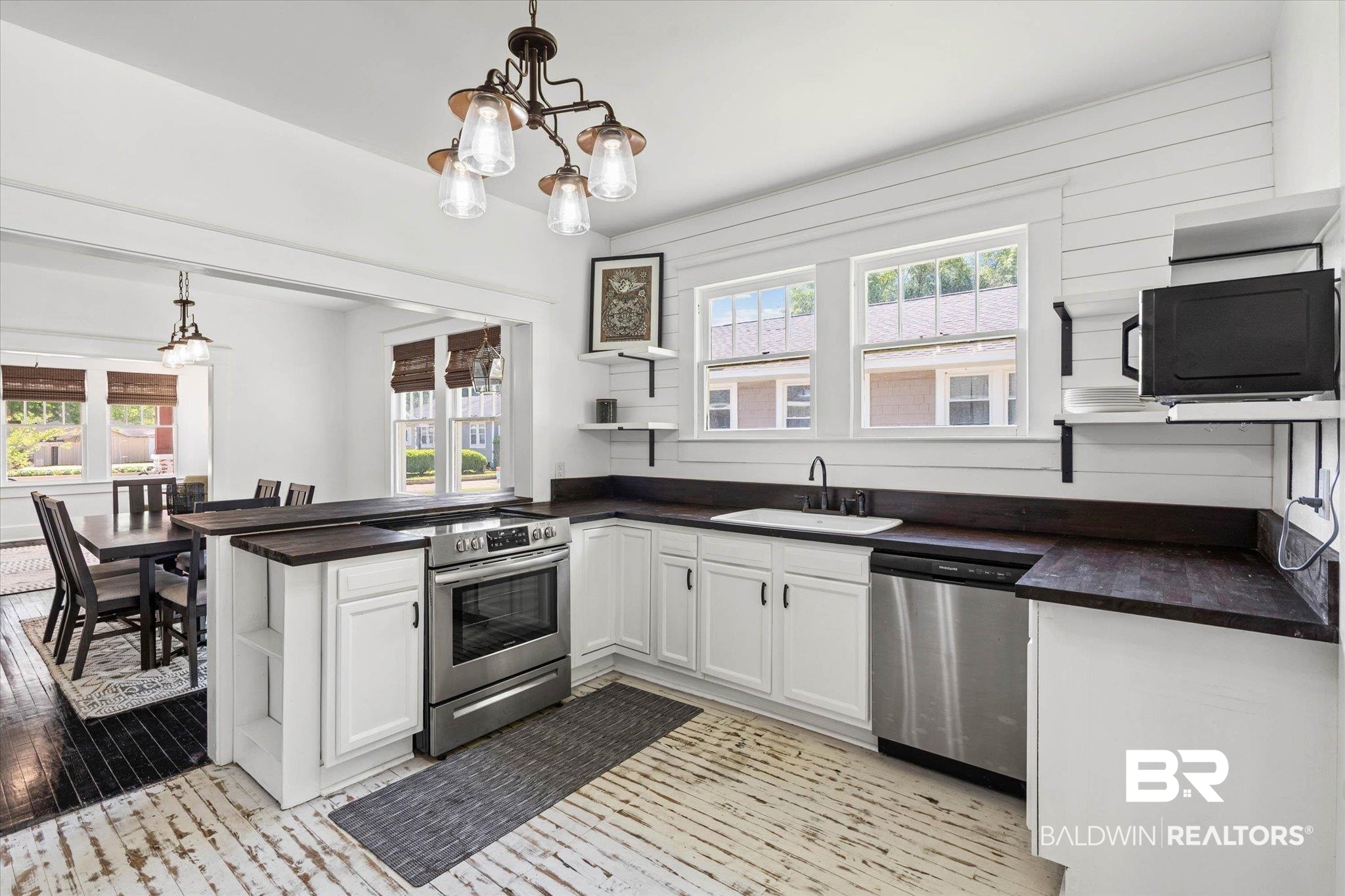 121 North Carlen Street Mobile, AL 36607 - Photo 7 of 21 Kitchen featuring open shelves, white cabinetry, stainless steel appliances, a peninsula, and plenty of natural light
