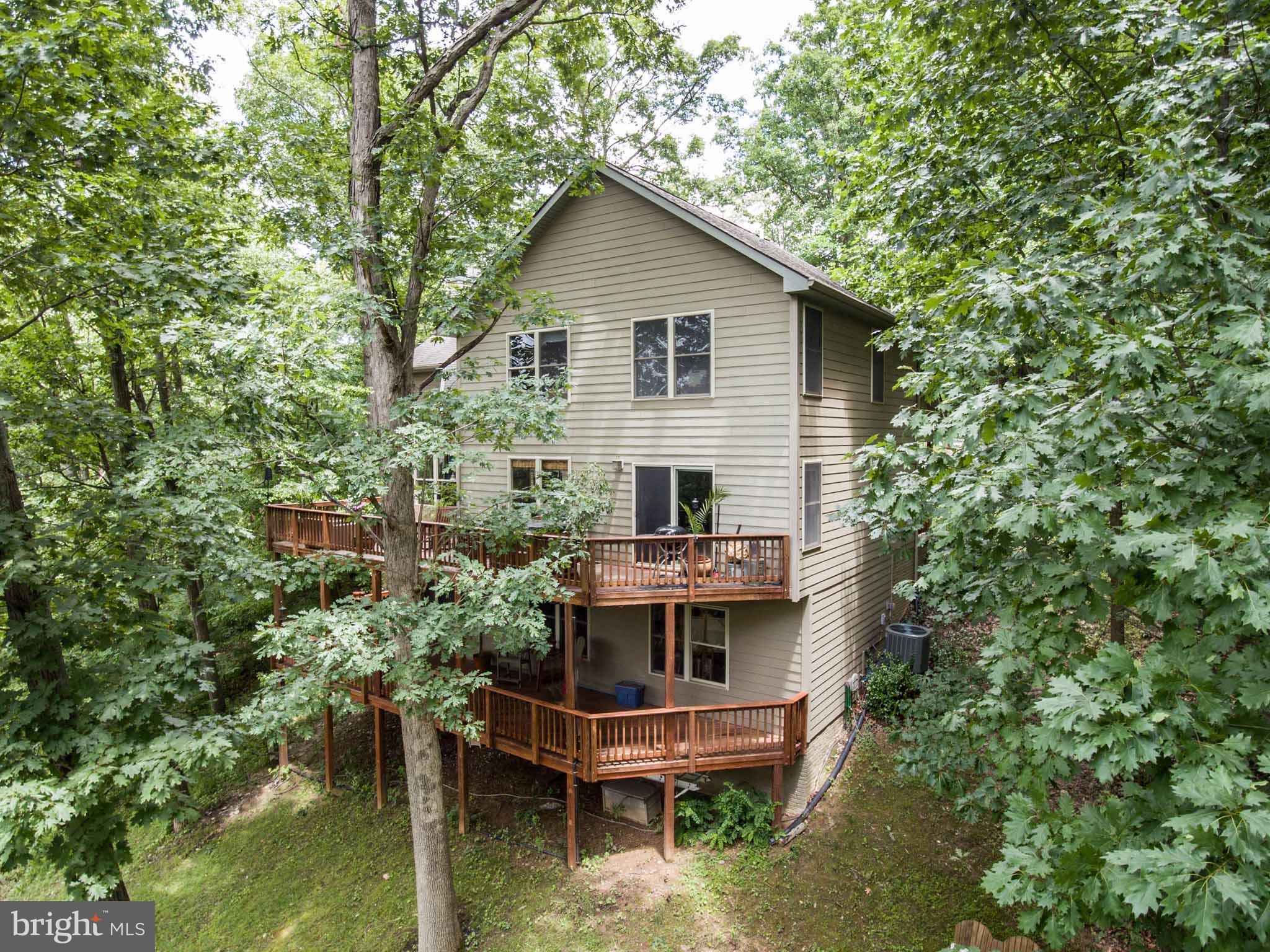 6704 West Lakeridge Road New Market, MD 21774 - Photo 21 of 30 a view of house with swimming pool and trees in the background
