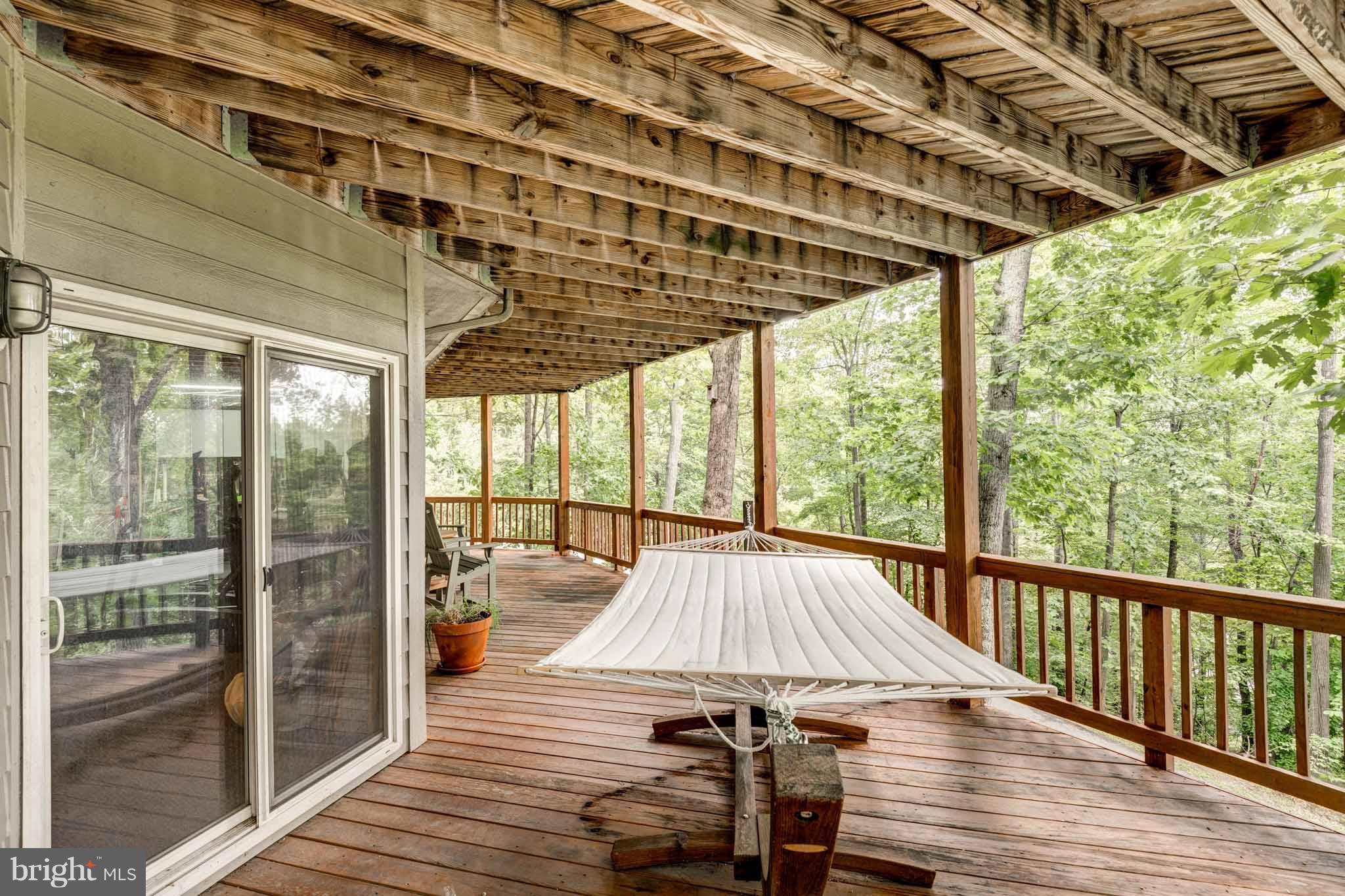 6704 West Lakeridge Road New Market, MD 21774 - Photo 25 of 30 a view of a patio with wooden floor table and chairs