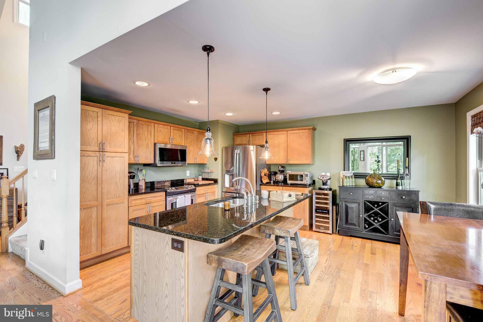 6704 West Lakeridge Road New Market, MD 21774 - Photo 5 of 30 a kitchen with stainless steel appliances granite countertop a sink a stove and a refrigerator