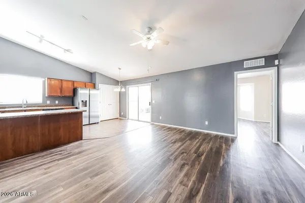 a view of a kitchen with wooden floor and a ceiling fan