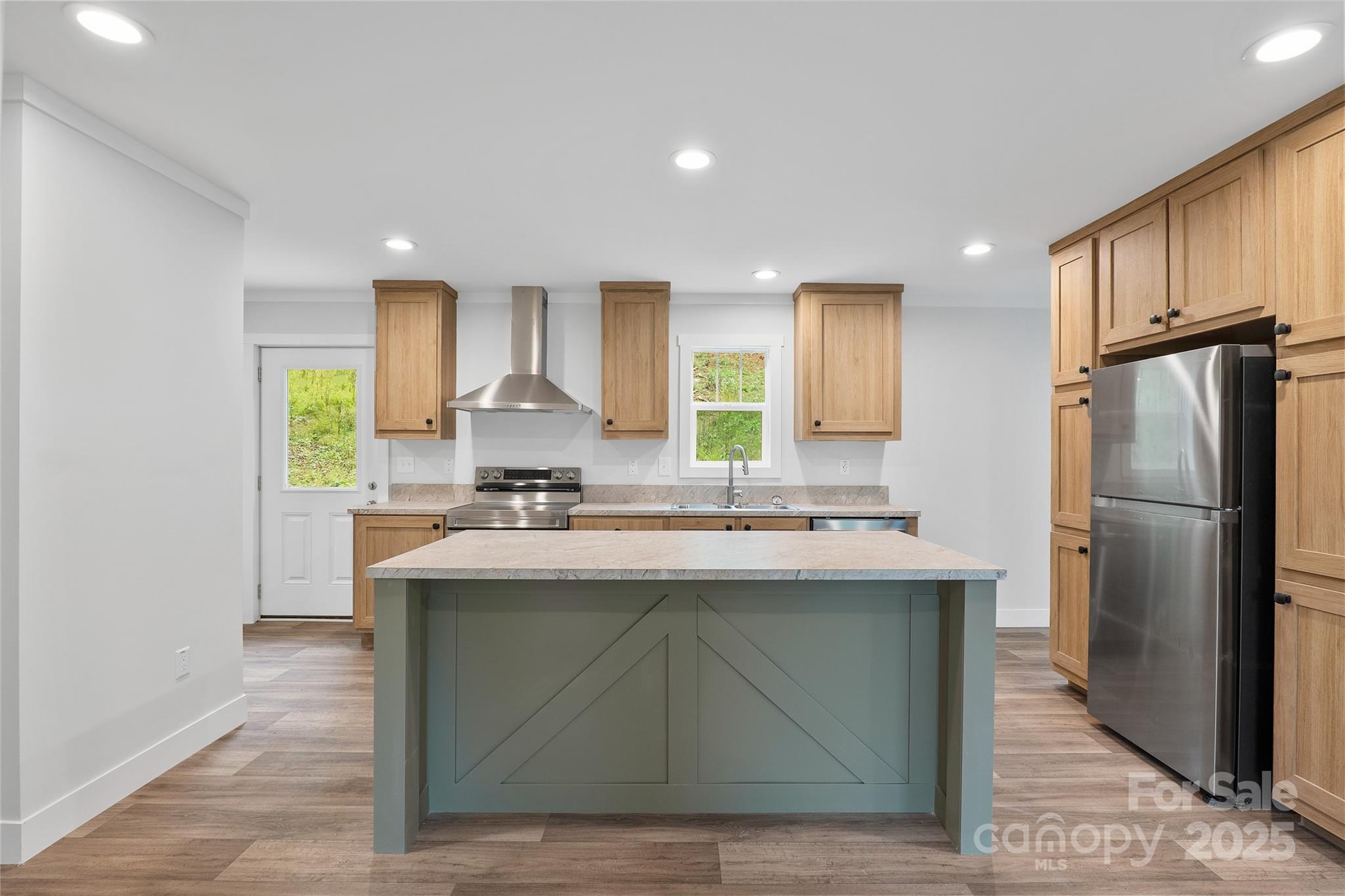 237 Hickory Nut Ridge Road, Unit 10 Burnsville, NC 28714 - Photo 11 of 42 a kitchen with kitchen island a sink stove and refrigerator