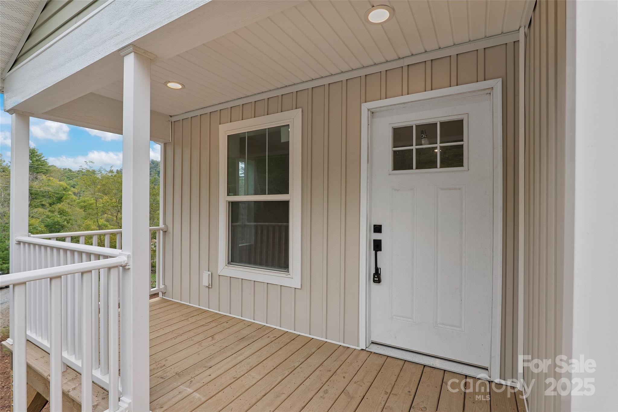237 Hickory Nut Ridge Road, Unit 10 Burnsville, NC 28714 - Photo 2 of 42 a view of a balcony with wooden floor and fence