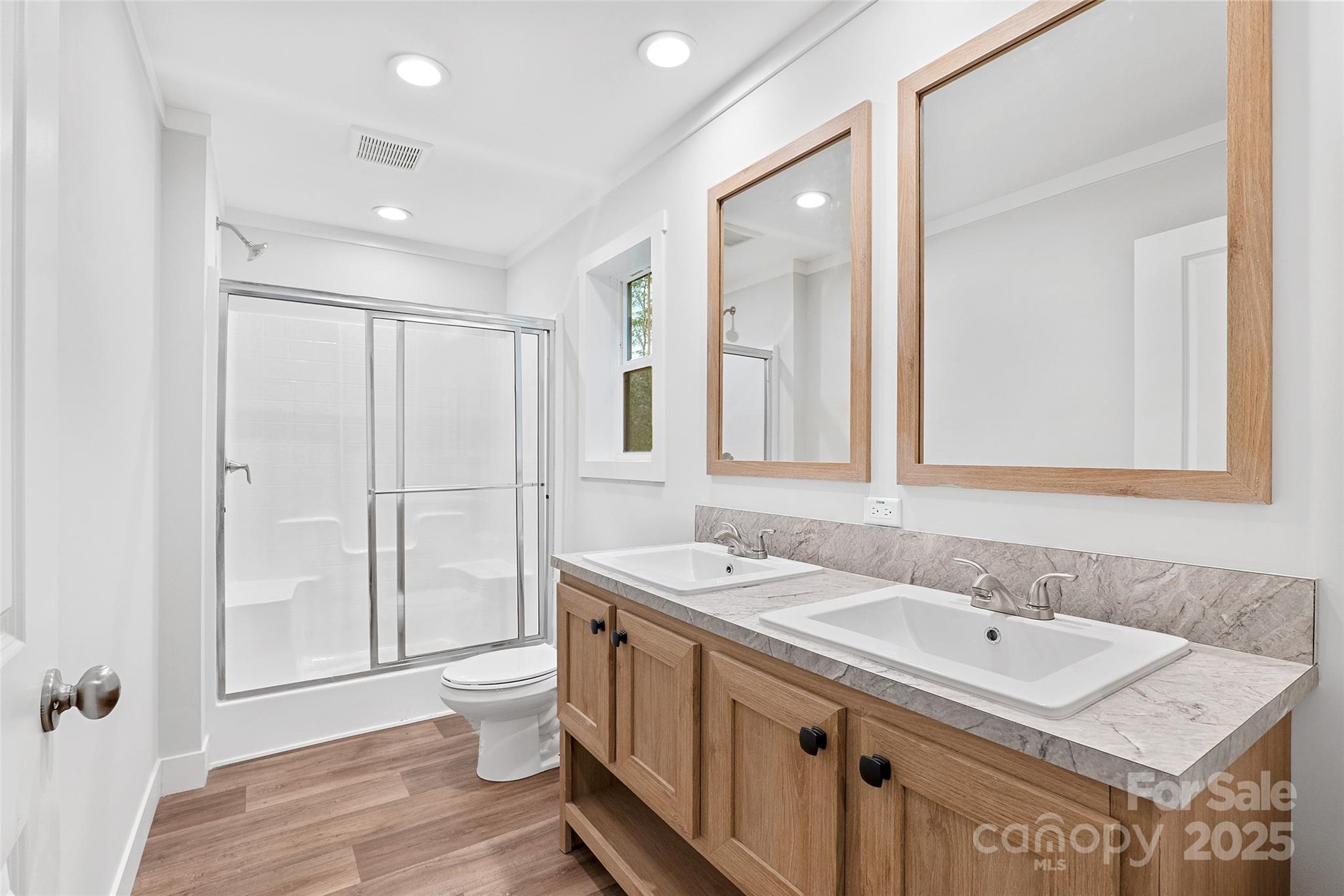 237 Hickory Nut Ridge Road, Unit 10 Burnsville, NC 28714 - Photo 28 of 42 a bathroom with a sink double vanity and a toilet