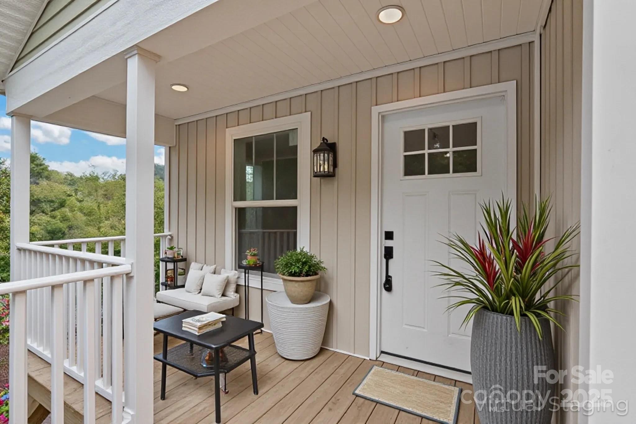 237 Hickory Nut Ridge Road, Unit 10 Burnsville, NC 28714 - Photo 3 of 42 a living room with patio furniture and potted plants