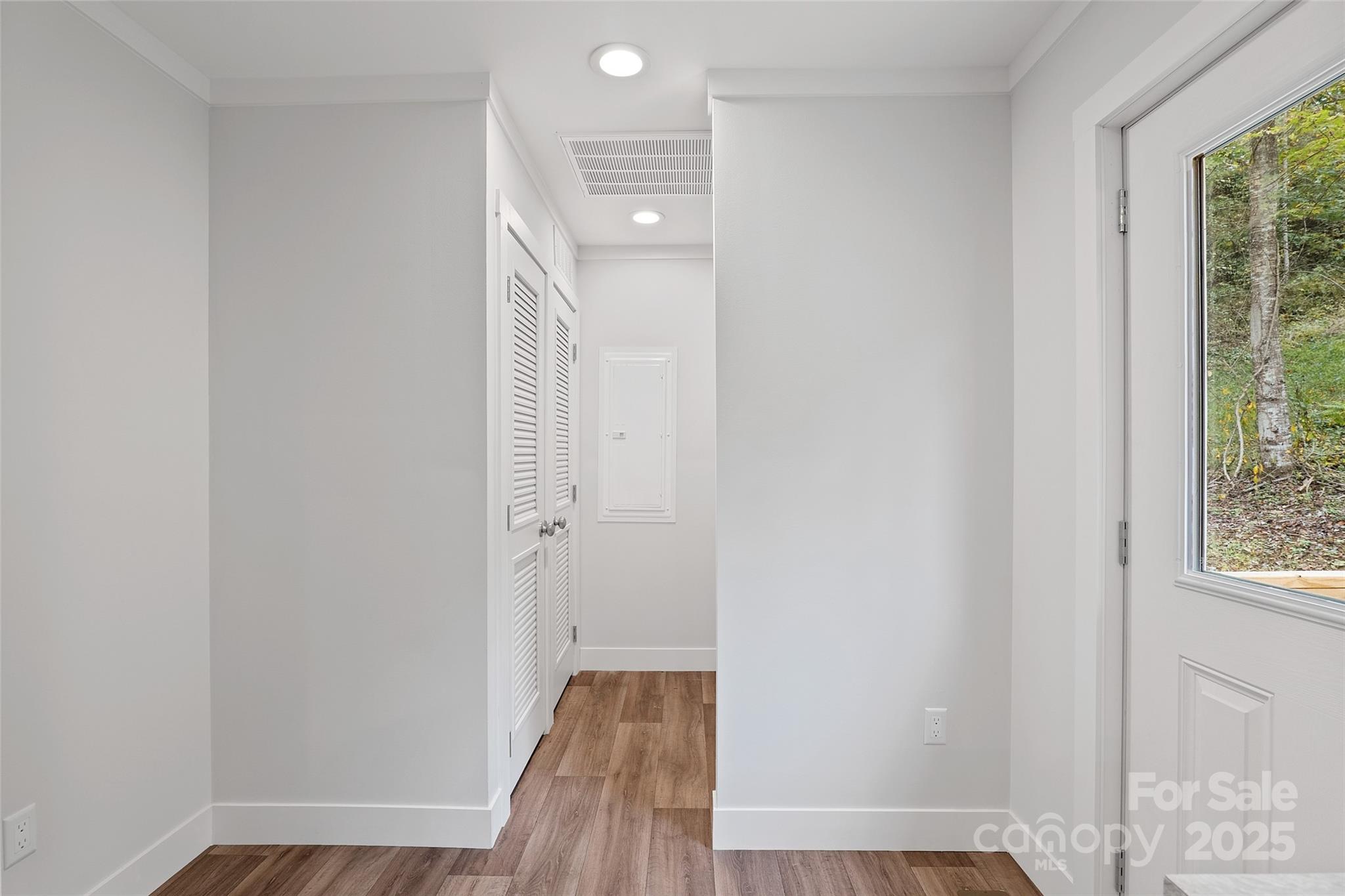 237 Hickory Nut Ridge Road, Unit 10 Burnsville, NC 28714 - Photo 32 of 42 a view of a hallway with wooden floor and closet