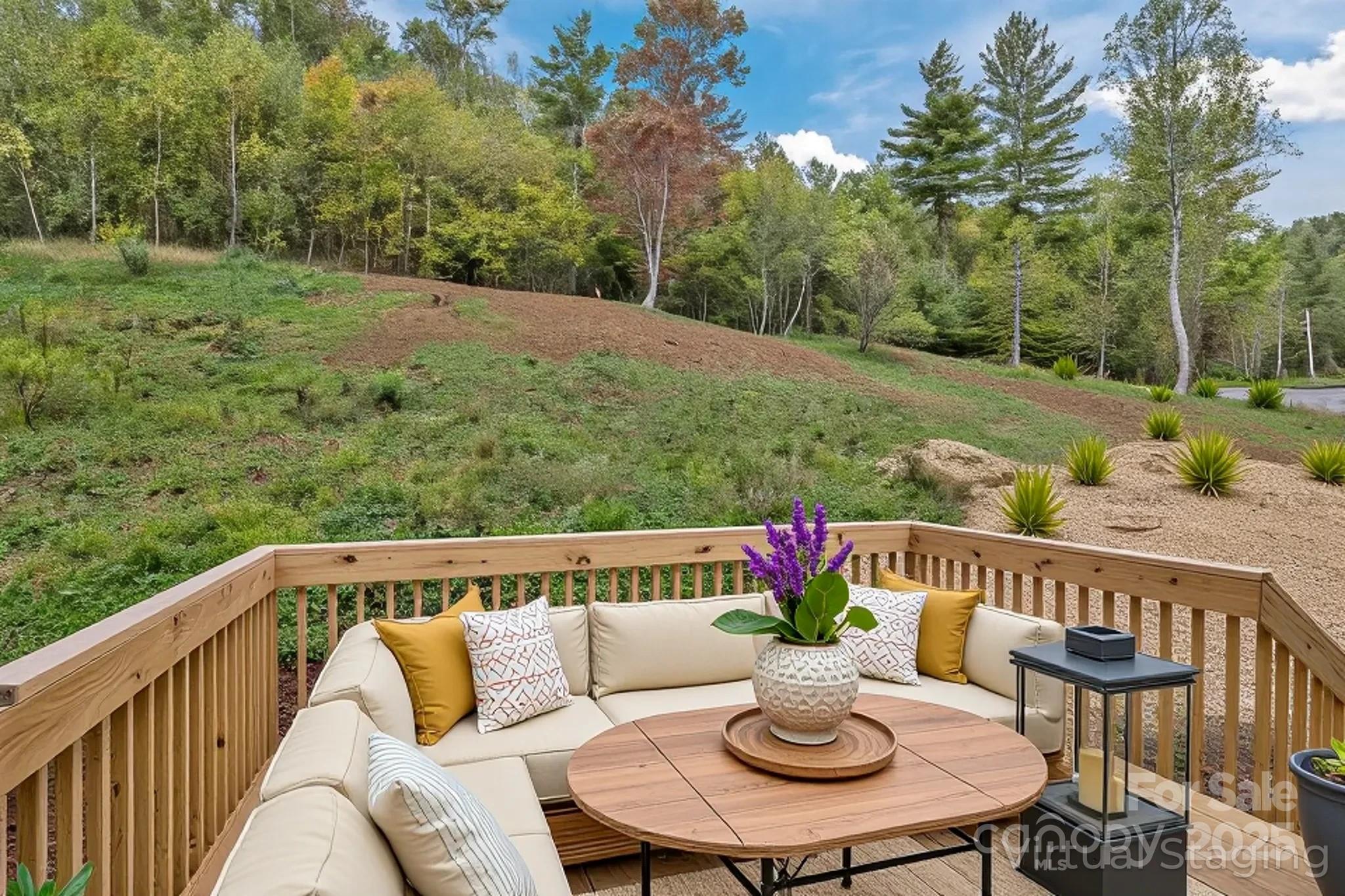 237 Hickory Nut Ridge Road, Unit 10 Burnsville, NC 28714 - Photo 36 of 42 a view of a chairs and table on the deck