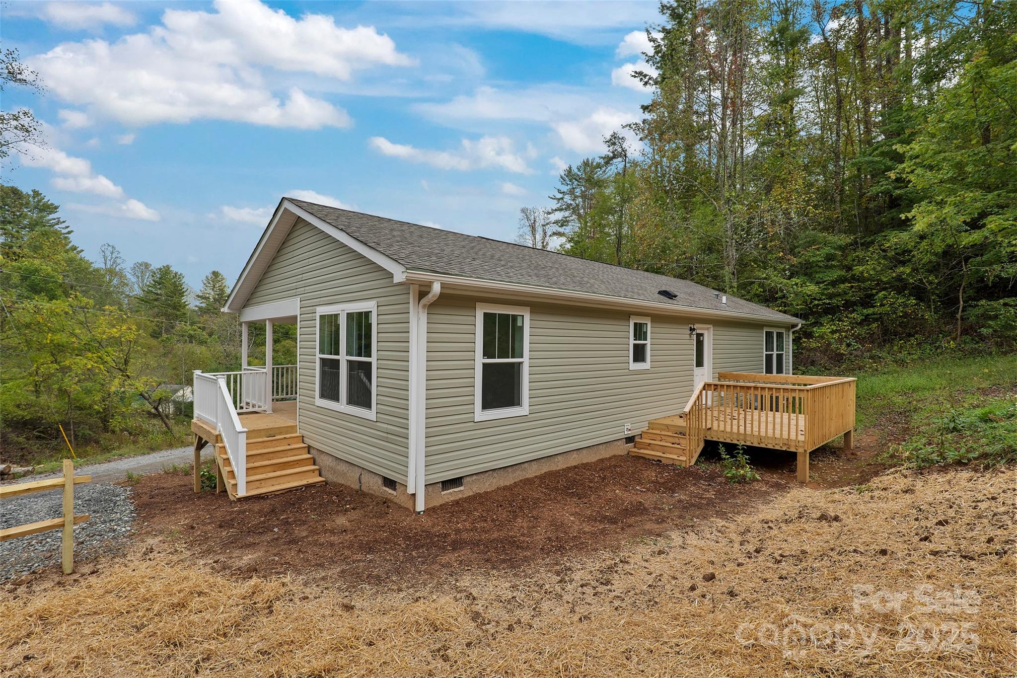 237 Hickory Nut Ridge Road, Unit 10 Burnsville, NC 28714 - Photo 37 of 42 a view of a house with a yard and wooden fence