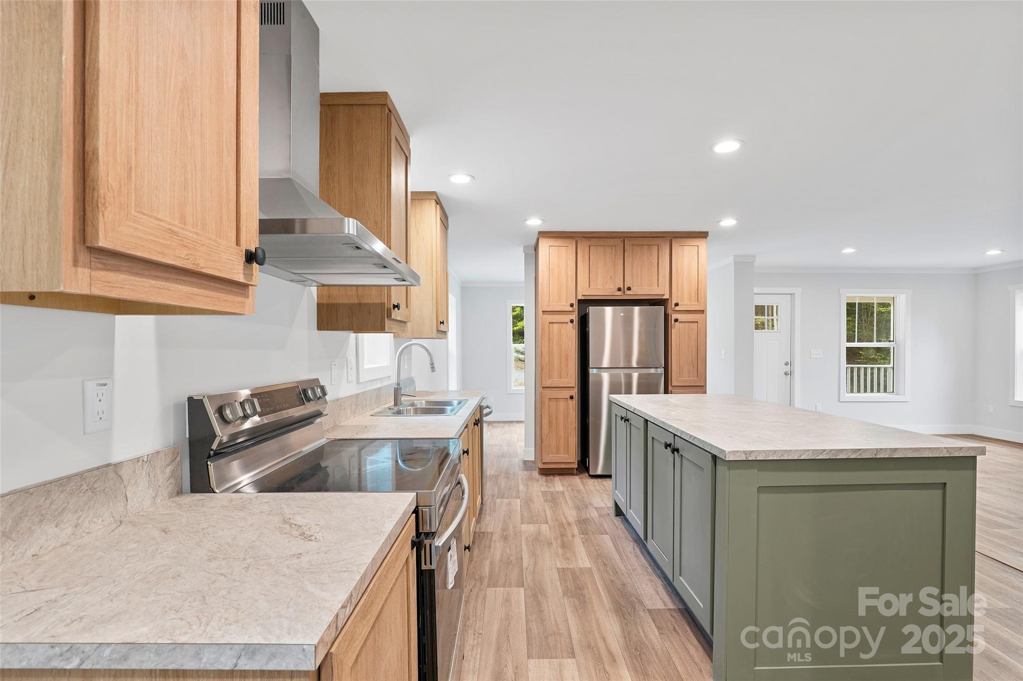 237 Hickory Nut Ridge Road, Unit 10 Burnsville, NC 28714 - Photo 9 of 42 a kitchen with stainless steel appliances granite countertop a sink a stove and a refrigerator