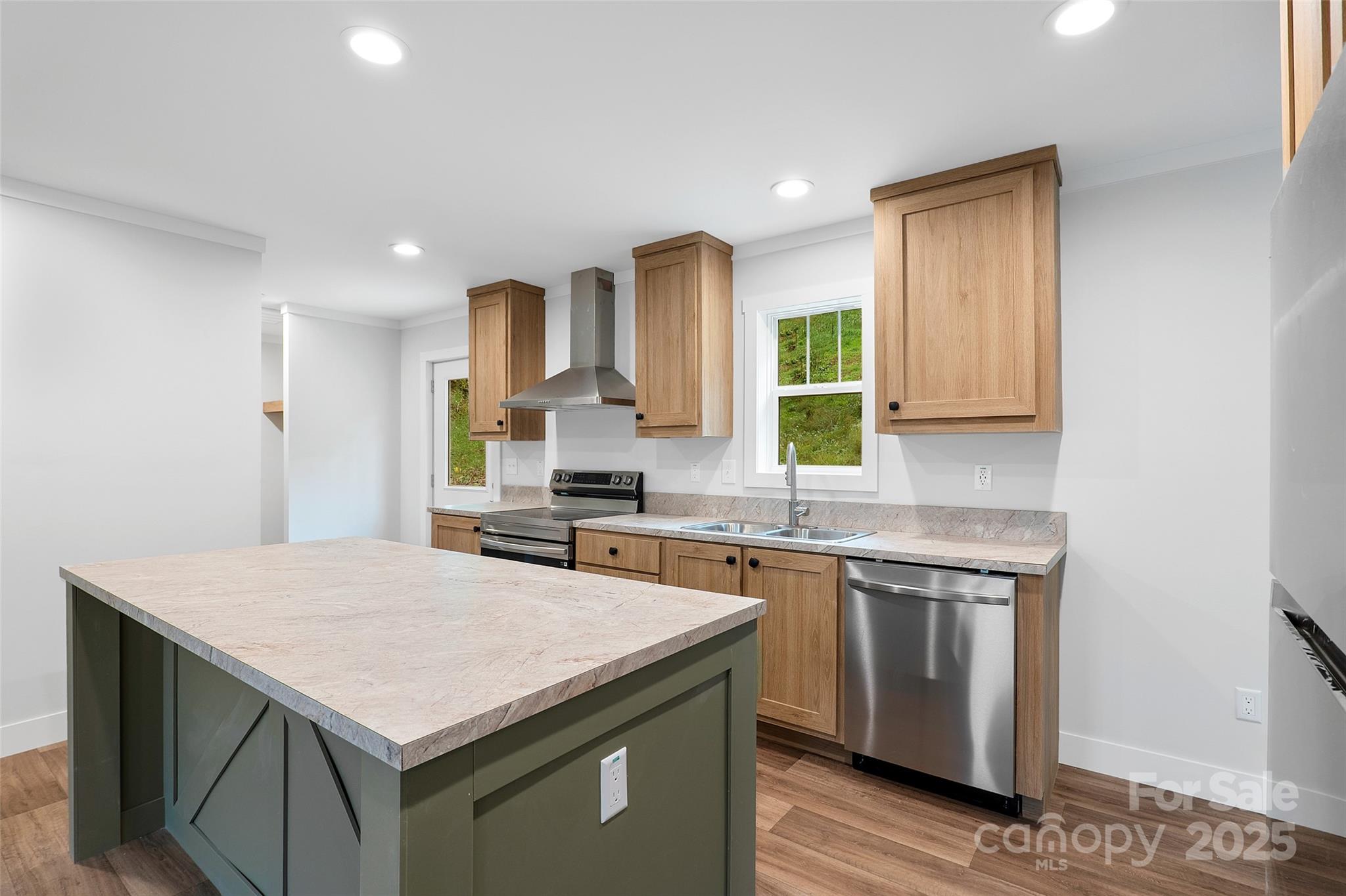 237 Hickory Nut Ridge Road, Unit 10 Burnsville, NC 28714 - Photo 10 of 42 a kitchen with a stove a sink a refrigerator and wooden floor