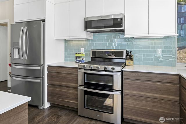 a kitchen with stainless steel appliances and wooden cabinets
