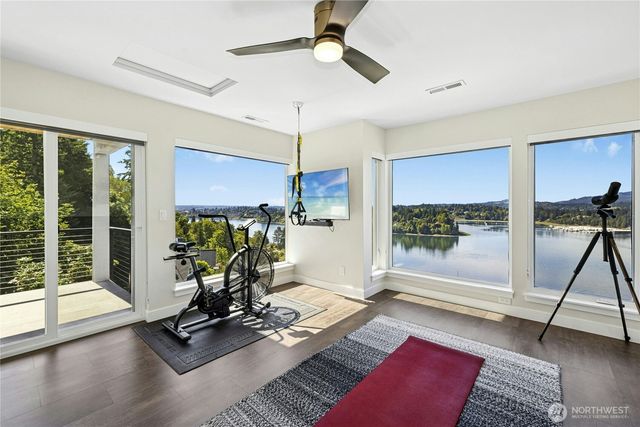 a view of a livingroom with furniture wooden floor and a floor to ceiling window