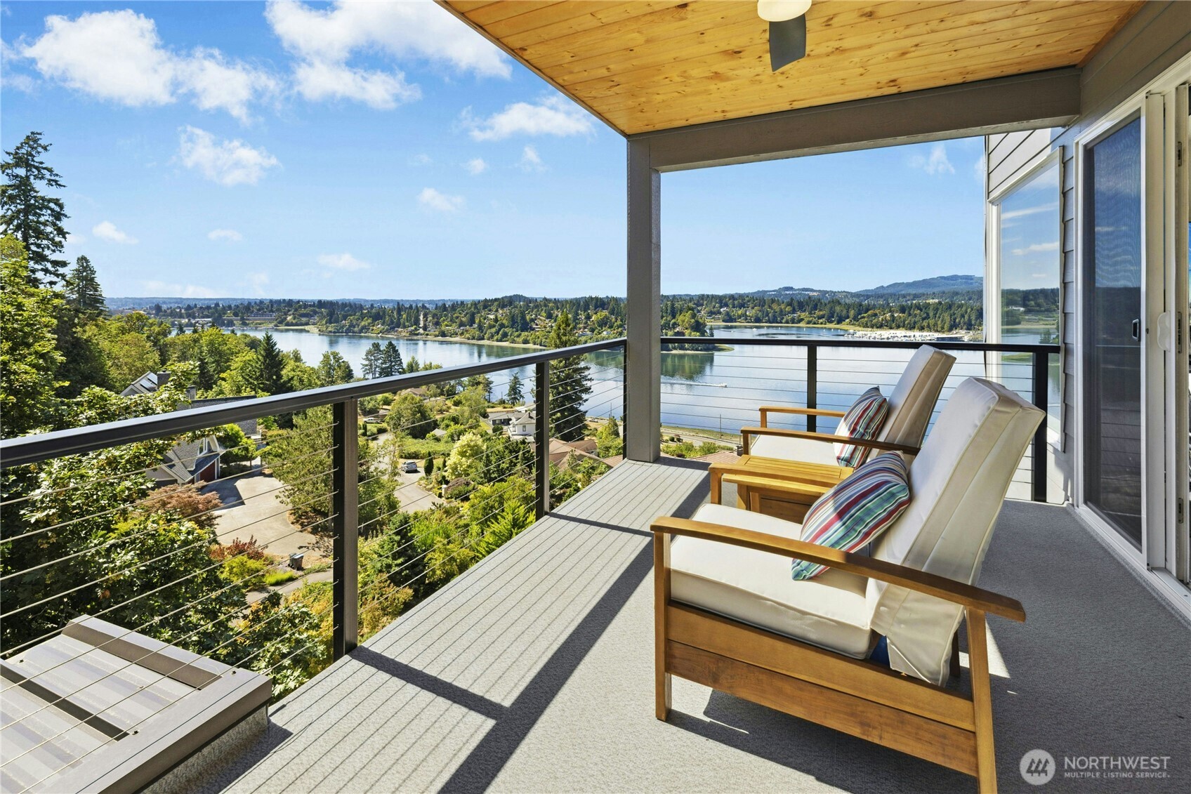 3347 Amak Lane Bremerton, WA 98310 - Photo 18 of 36 a view of a balcony with chairs and wooden floor
