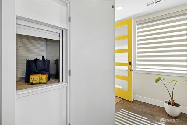 a view of walk in closet with living room and windows