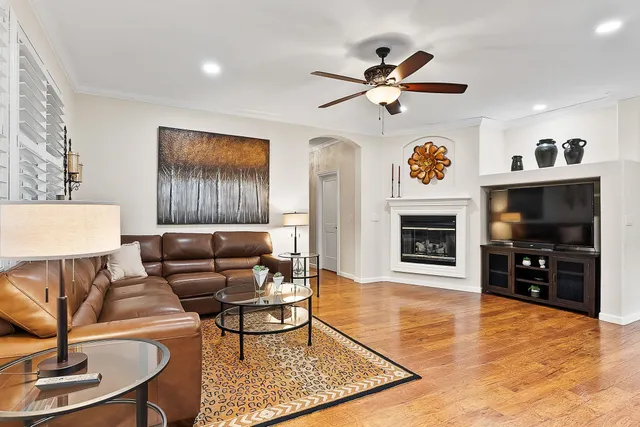 a living room with furniture a flat screen tv and a fireplace