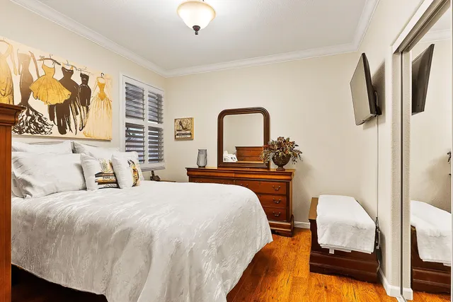 a bedroom with a bed and a painting on the wall