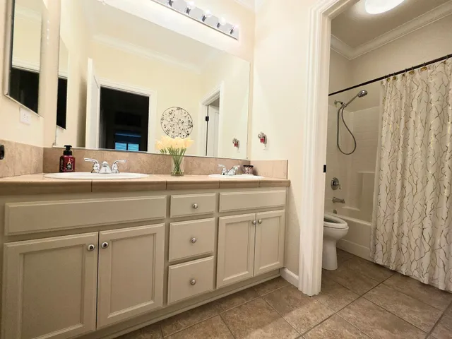 a bathroom with a double vanity sink and mirror