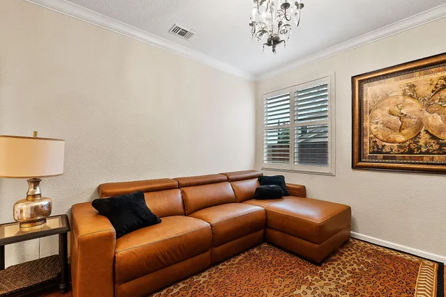 a living room with furniture a couch and a chandelier