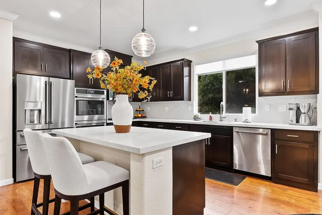 a kitchen with sink cabinets and refrigerator