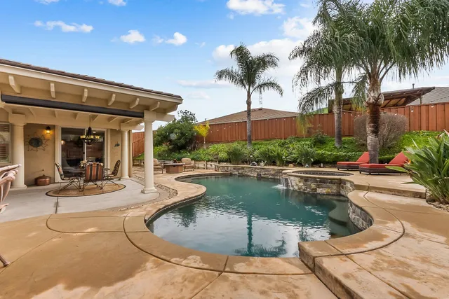 a view of a swimming pool with chairs