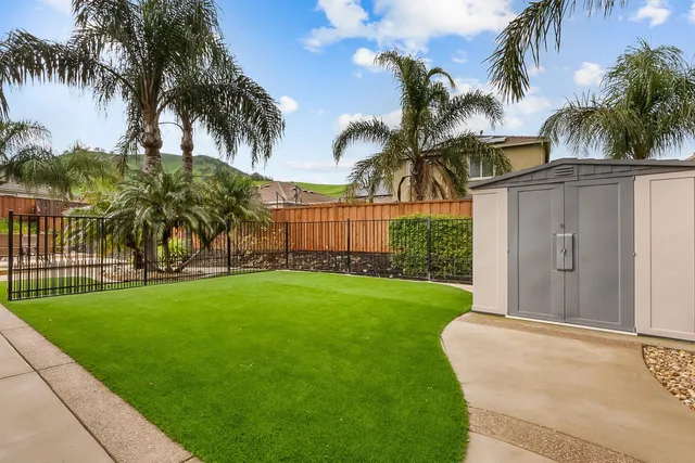 a view of a yard in front of a house with a garden