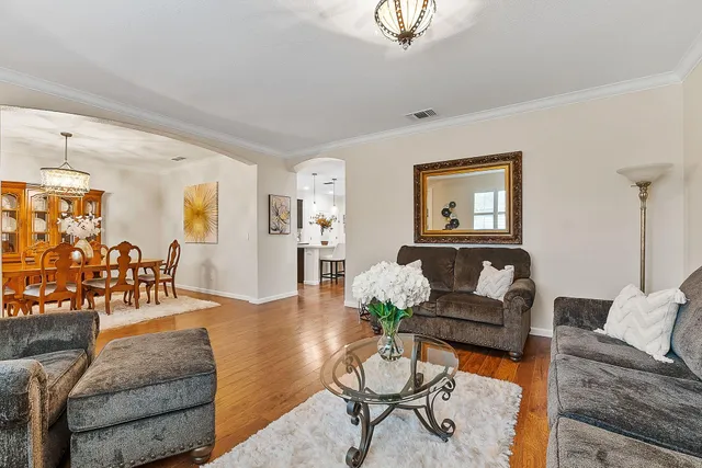 a living room with furniture and wooden floor