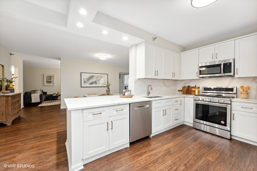 55 West Delaware Place, Unit 415 Chicago, IL 60610 - Photo 11 of 41 a kitchen with granite countertop white cabinets and appliances