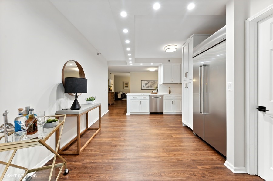 55 West Delaware Place, Unit 415 Chicago, IL 60610 - Photo 13 of 41 a view of a kitchen with furniture and wooden floor