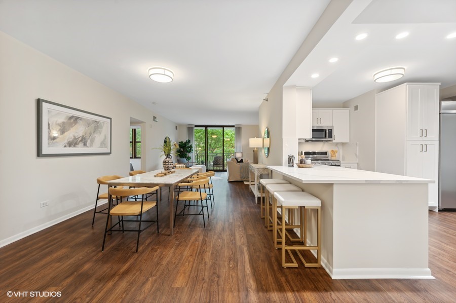 55 West Delaware Place, Unit 415 Chicago, IL 60610 - Photo 14 of 41 a living room with stainless steel appliances a dining table wooden floor and a view of kitchen