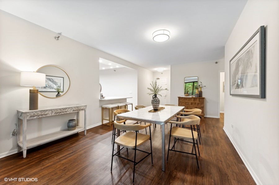 55 West Delaware Place, Unit 415 Chicago, IL 60610 - Photo 16 of 41 a view of a dining room with furniture a fireplace and wooden floor