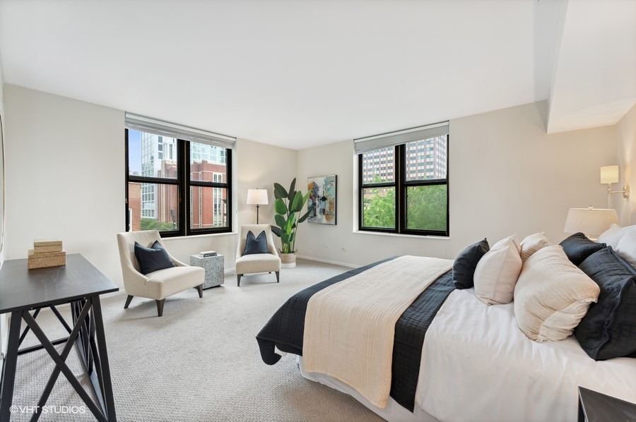 55 West Delaware Place, Unit 415 Chicago, IL 60610 - Photo 18 of 41 a bedroom with a bed and large window