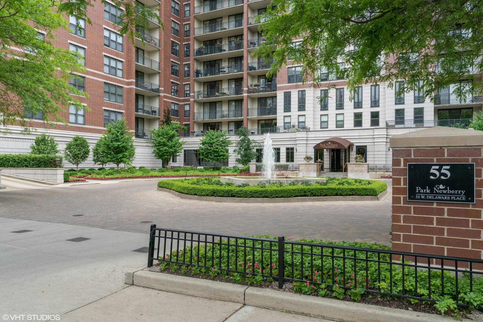 55 West Delaware Place, Unit 415 Chicago, IL 60610 - Photo 2 of 41 a front view of a building with a garden and plants