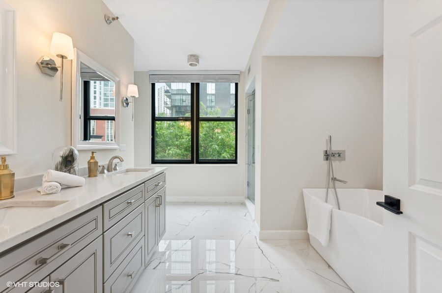55 West Delaware Place, Unit 415 Chicago, IL 60610 - Photo 21 of 41 a bathroom with a tub sink and mirror
