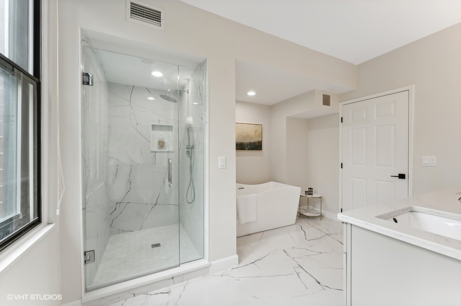 55 West Delaware Place, Unit 415 Chicago, IL 60610 - Photo 22 of 41 a bathroom with a bathtub shower and toilet