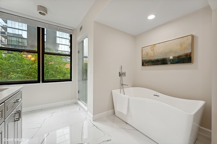 55 West Delaware Place, Unit 415 Chicago, IL 60610 - Photo 23 of 41 a bathroom with a bathtub and window